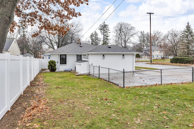 rear view of house with a yard