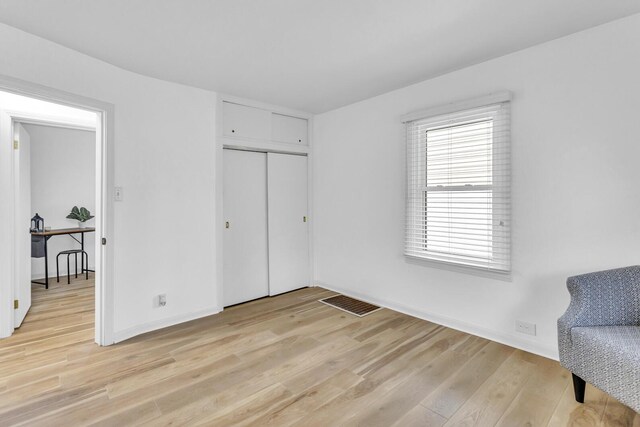 bedroom featuring a closet and light hardwood / wood-style flooring