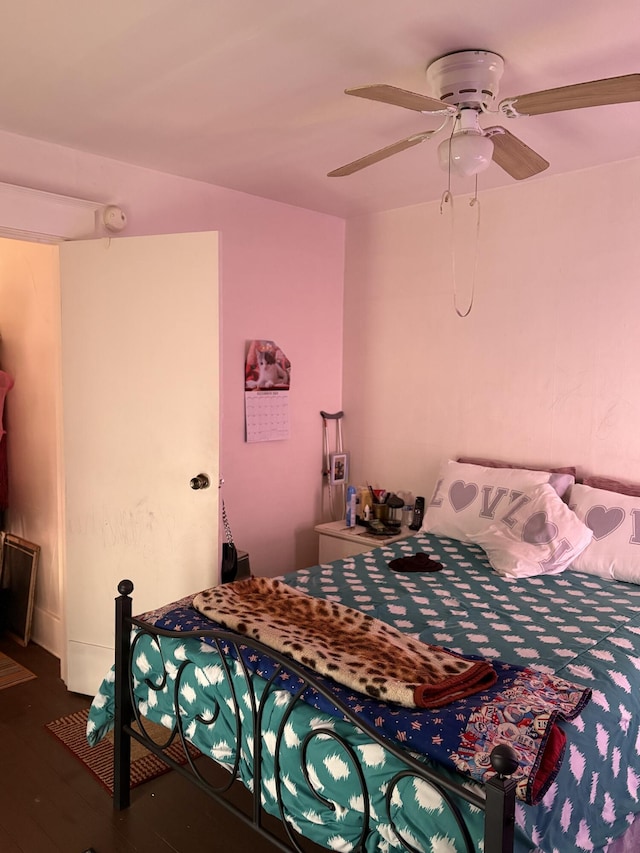 bedroom featuring ceiling fan and dark wood-type flooring