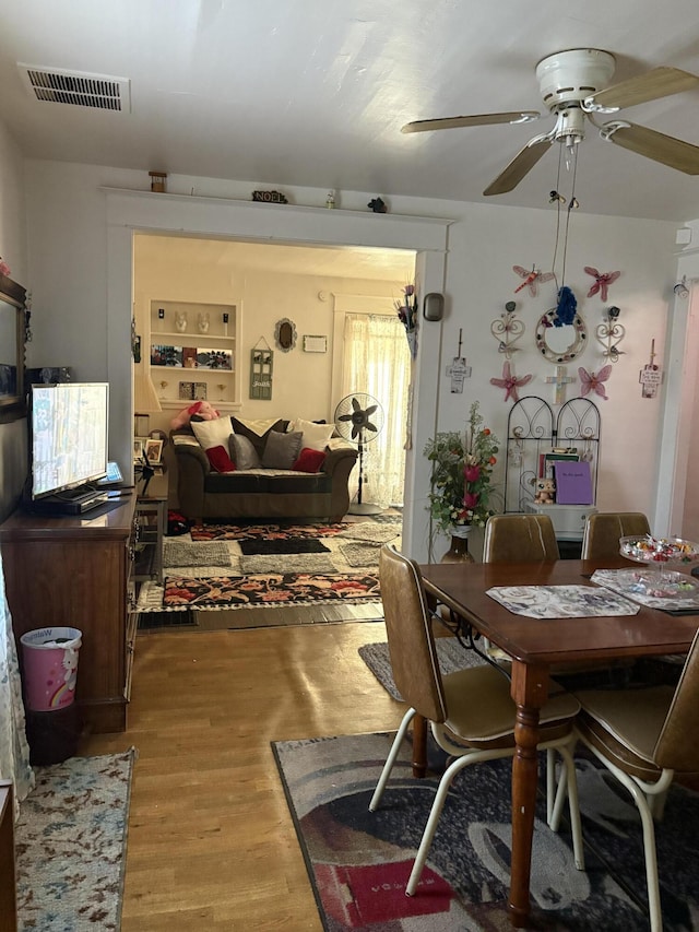 dining space featuring hardwood / wood-style flooring and ceiling fan