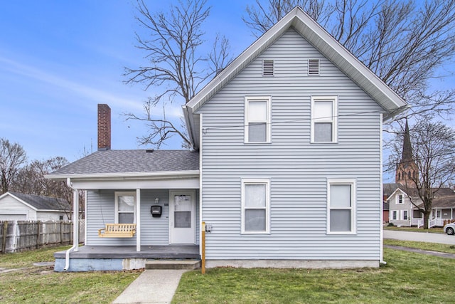 view of front of home featuring a front yard and a porch