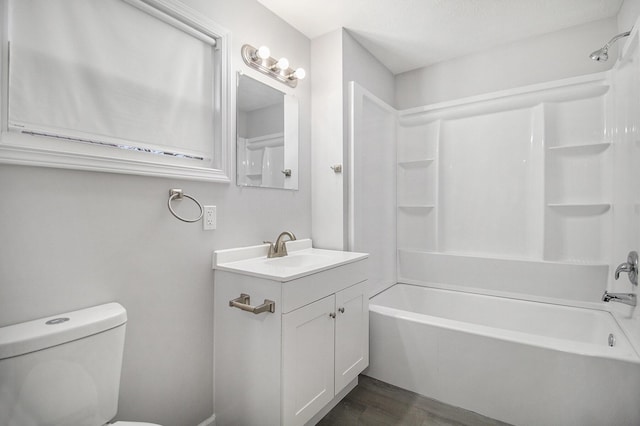 full bathroom with hardwood / wood-style floors, vanity, toilet, and shower / washtub combination