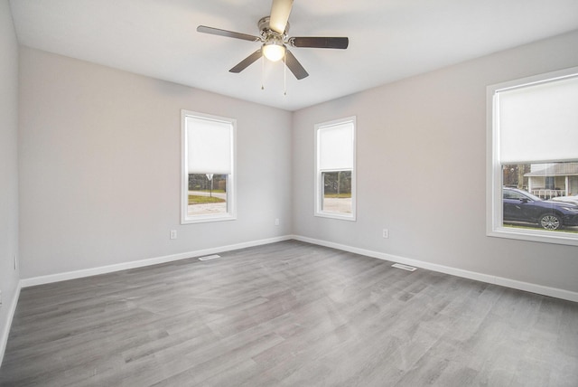 unfurnished room with light wood-type flooring and ceiling fan