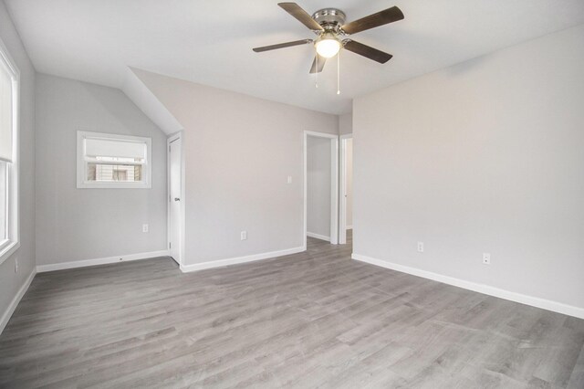 spare room with ceiling fan, light hardwood / wood-style floors, and lofted ceiling