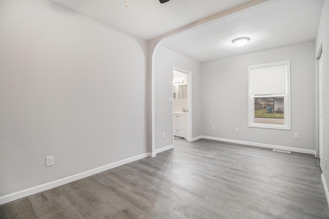 unfurnished room with ceiling fan and hardwood / wood-style floors