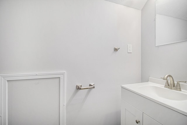 bathroom with vanity and a textured ceiling