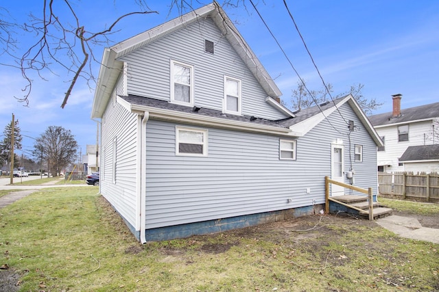 rear view of house with a lawn