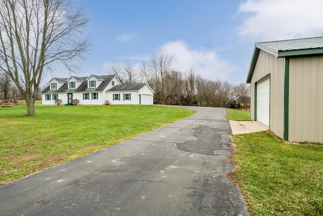 exterior space featuring a lawn and a garage