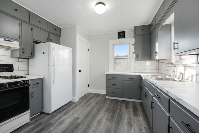 kitchen with gray cabinetry, white appliances, sink, and tasteful backsplash