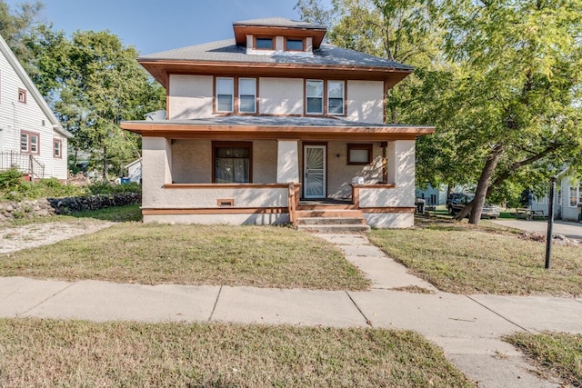 view of front of house with covered porch and a front yard