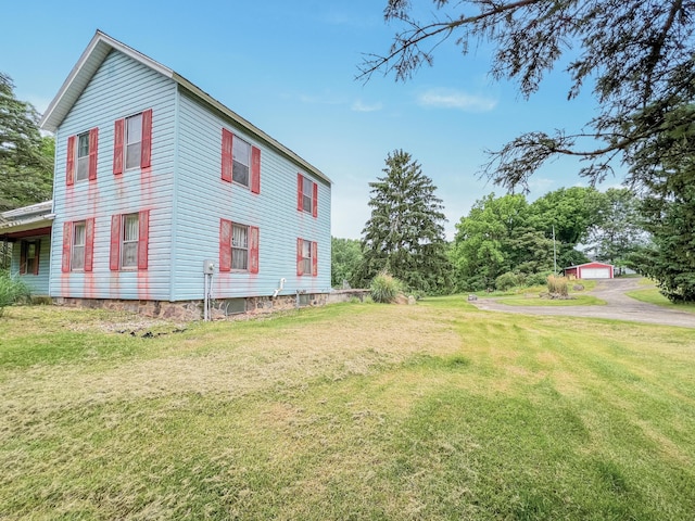 view of side of property with a lawn