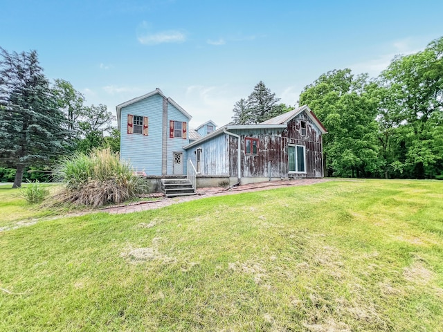 back of property featuring a lawn