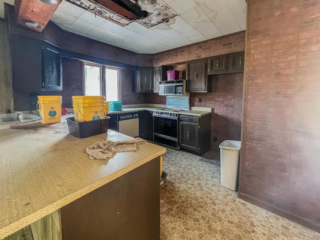 kitchen with dishwasher, range with electric stovetop, dark brown cabinetry, and brick wall