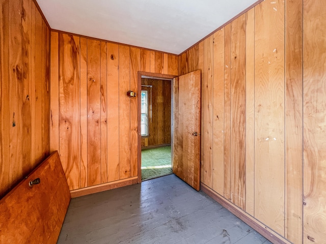 empty room featuring wooden walls