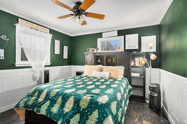 bedroom with ceiling fan, dark hardwood / wood-style flooring, and crown molding