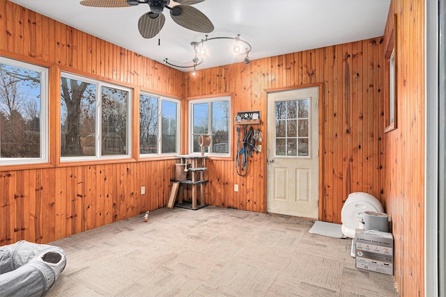 unfurnished sunroom with ceiling fan