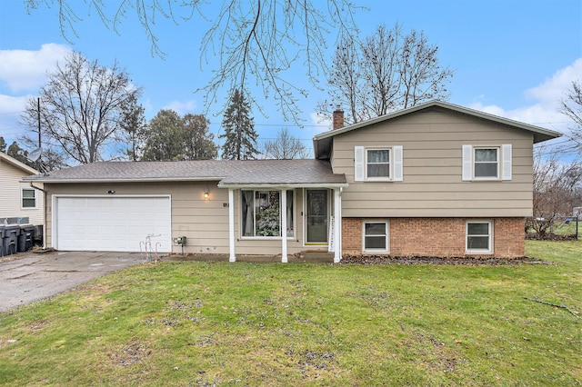 split level home with a front yard and a garage