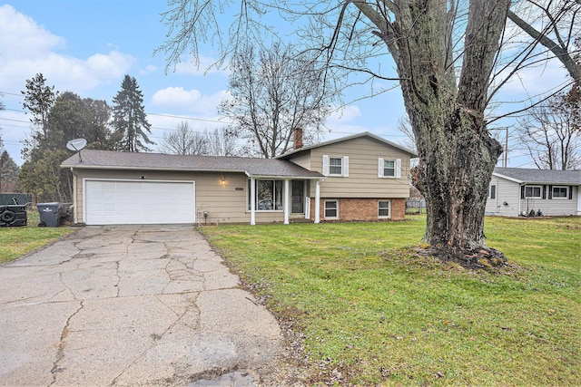 split level home featuring a garage and a front lawn