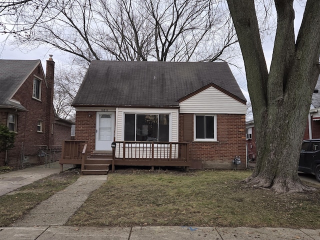 bungalow-style home with a front lawn