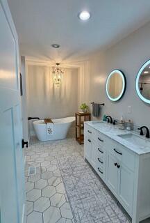 bathroom featuring vanity, tile patterned floors, and a bathtub