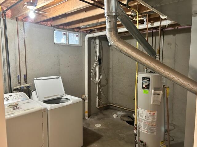 basement featuring separate washer and dryer and water heater