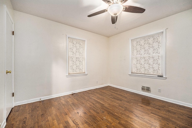 empty room with ceiling fan and dark wood-type flooring