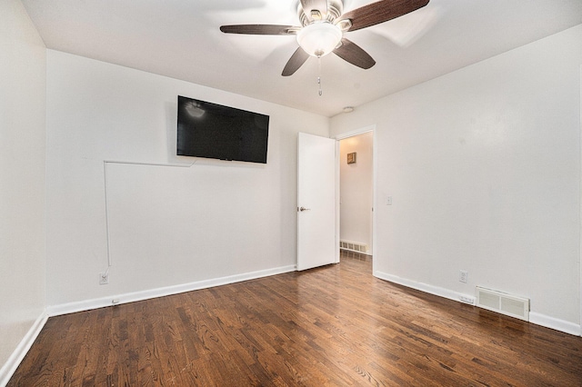 unfurnished room featuring ceiling fan and dark wood-type flooring