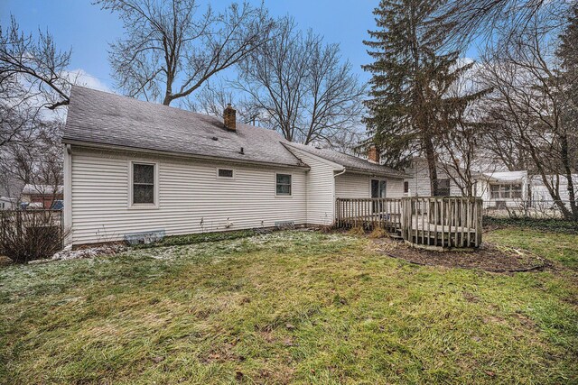 back of house featuring a deck and a yard