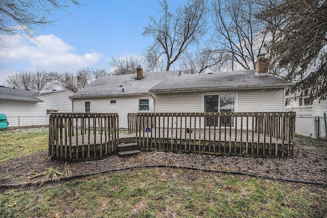 back of house with a yard and a deck