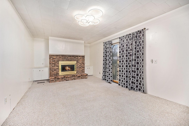 unfurnished living room with carpet flooring and a fireplace