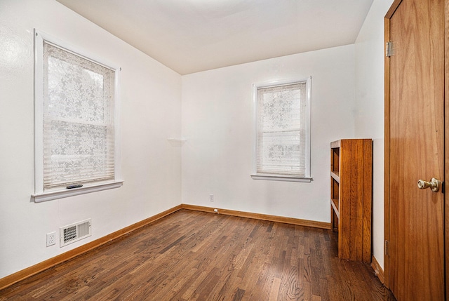 unfurnished room featuring dark hardwood / wood-style floors