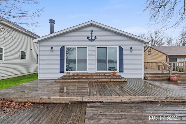 rear view of property with a wooden deck