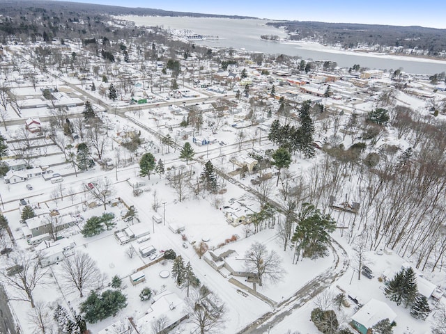 snowy aerial view featuring a water view