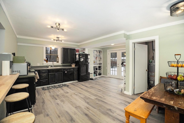 kitchen featuring french doors, light wood-type flooring, crown molding, sink, and black appliances