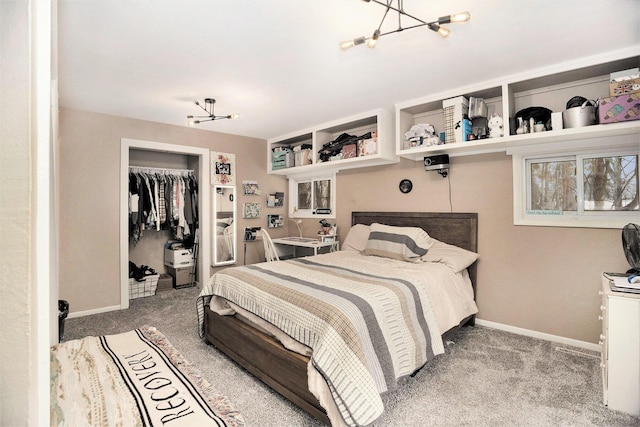 carpeted bedroom featuring a chandelier and a closet