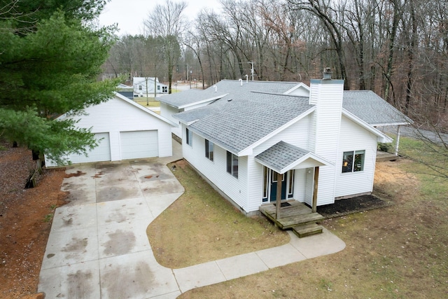 view of front of property featuring a garage and an outdoor structure