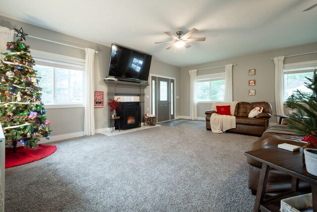 carpeted living room featuring ceiling fan