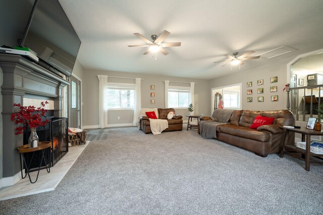 carpeted living room with ceiling fan and plenty of natural light