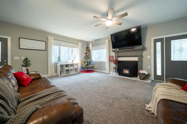 carpeted living room with ceiling fan