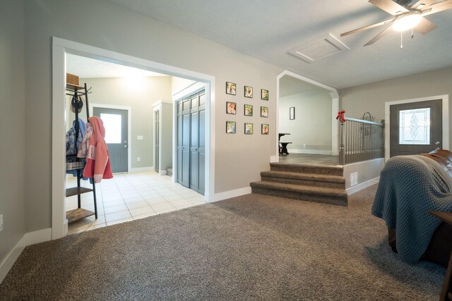 staircase with carpet and ceiling fan