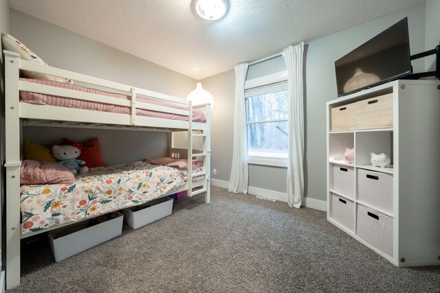 carpeted bedroom featuring a textured ceiling