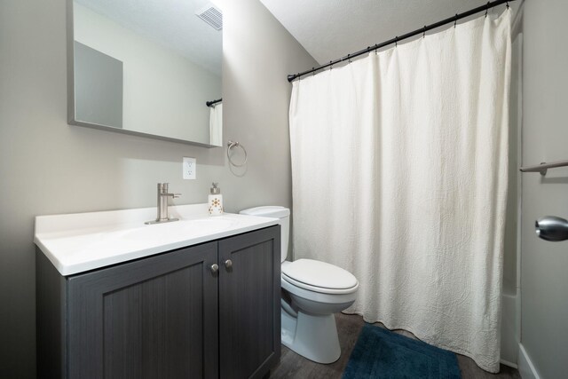 bathroom featuring hardwood / wood-style floors, vanity, and toilet