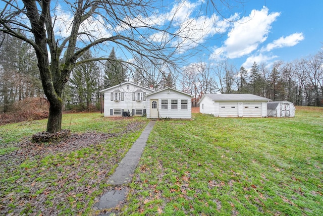 view of front of home with a front lawn and a storage unit