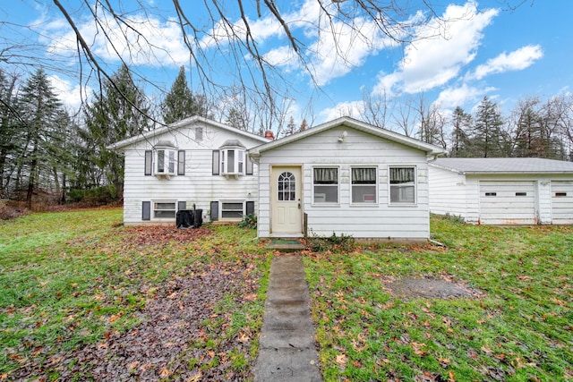 tri-level home with a front yard and a garage