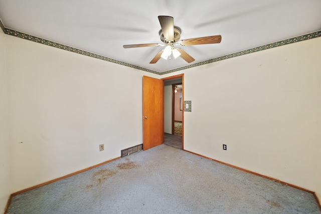 empty room featuring ceiling fan, crown molding, and carpet