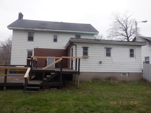 back of house featuring a yard and a deck