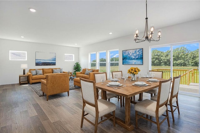 dining room featuring hardwood / wood-style floors, a notable chandelier, and a wealth of natural light