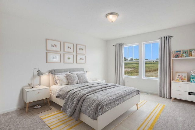 bedroom featuring light colored carpet