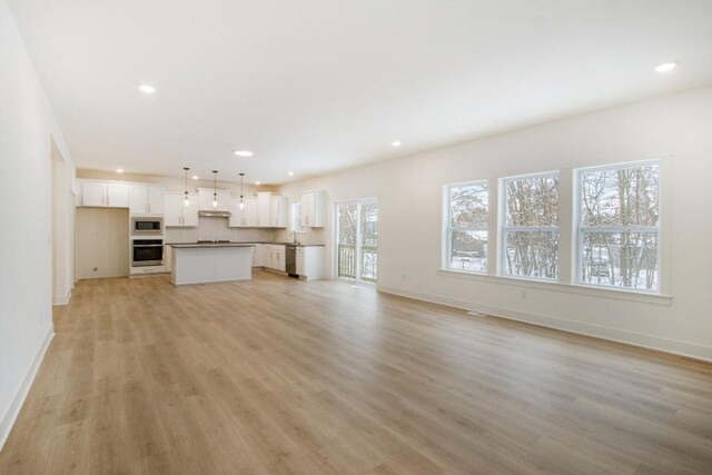 unfurnished living room featuring light hardwood / wood-style floors