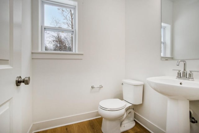 bathroom with hardwood / wood-style flooring, sink, and toilet